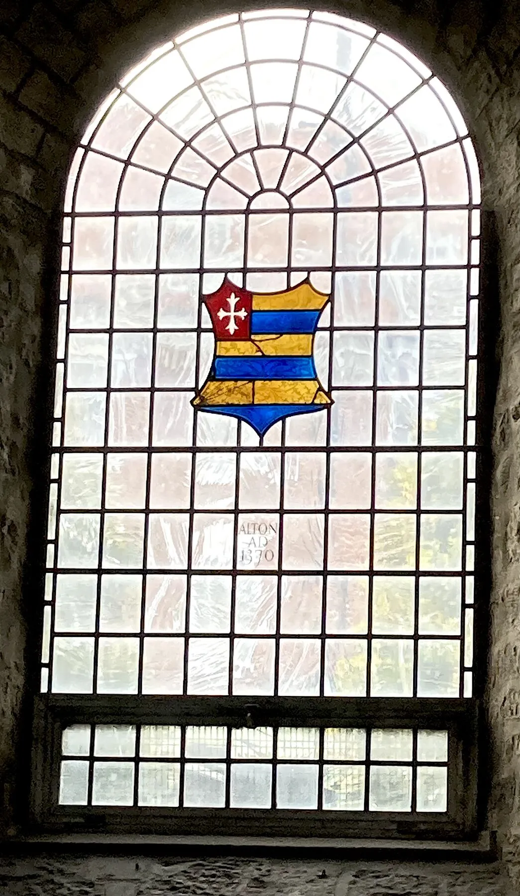 The whole round-headed window with the small shield near the centre