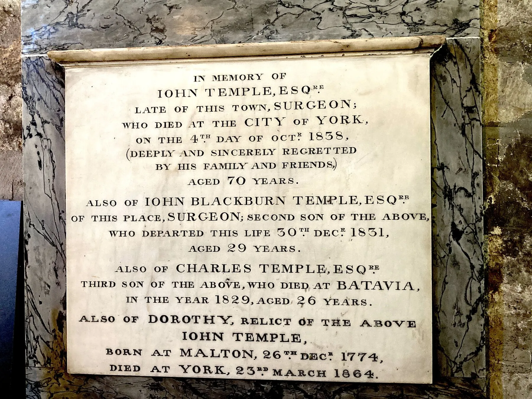 A white marble tablet with a long carved inscription
